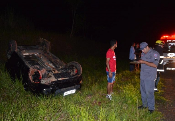 O carro capotou e parou alguns metros fora da pista com as rodas para cima